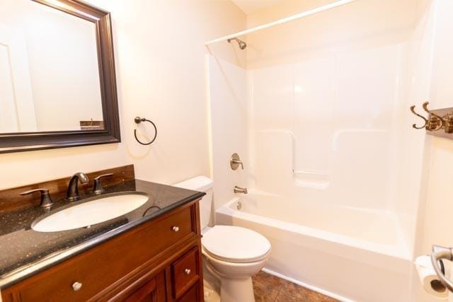 full bathroom with  shower combination, vanity, and toilet