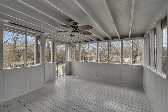 unfurnished sunroom with a ceiling fan