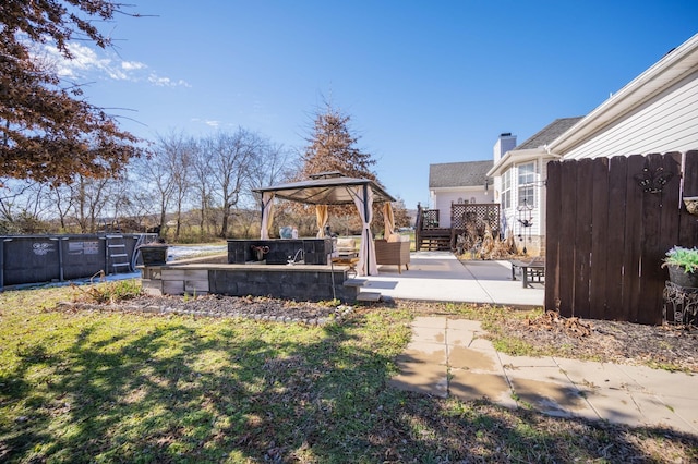 view of yard with fence, a patio, and a gazebo