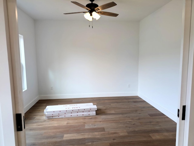 unfurnished room with ceiling fan, wood finished floors, and baseboards