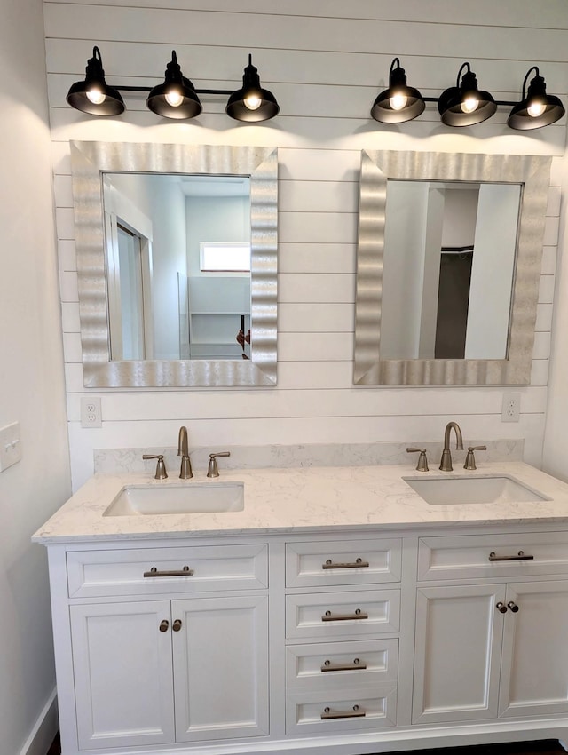 bathroom with a sink and double vanity