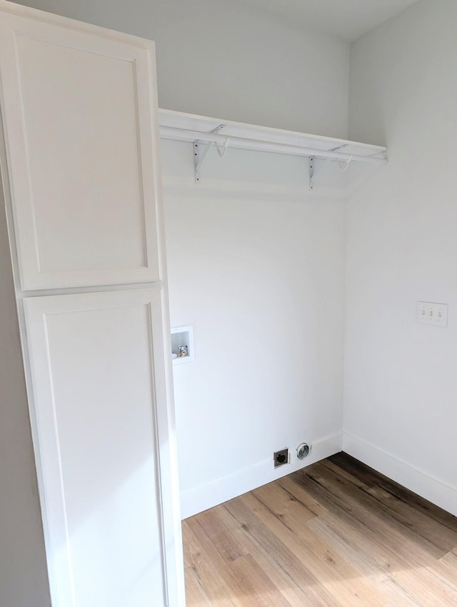 laundry room featuring laundry area, baseboards, hookup for a washing machine, hookup for an electric dryer, and light wood-style floors