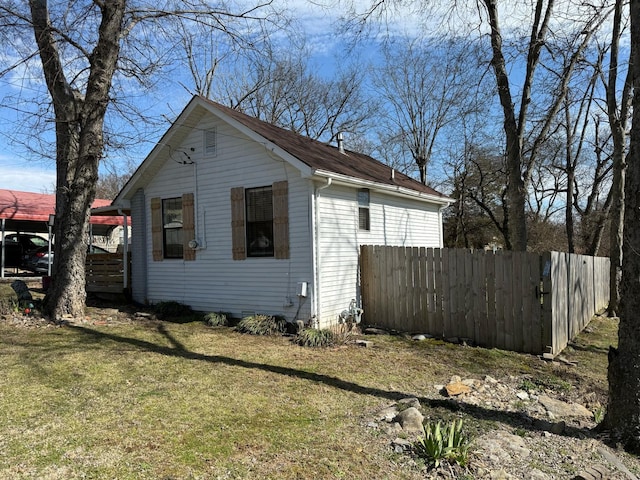 view of home's exterior featuring a yard and fence