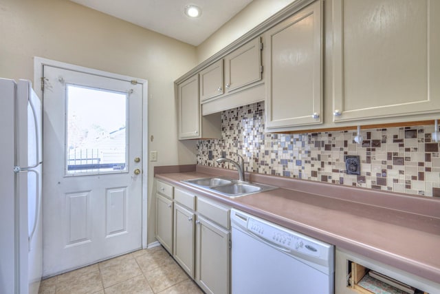 kitchen with a sink, backsplash, white appliances, light tile patterned flooring, and light countertops