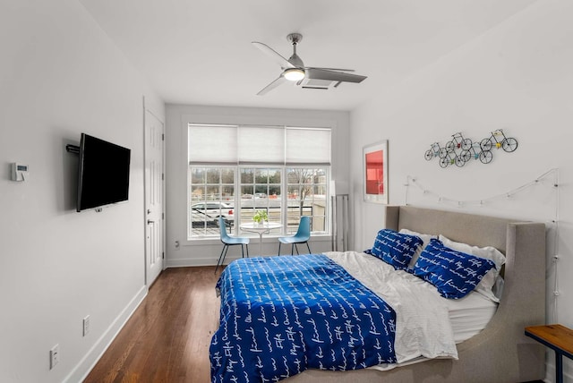 bedroom featuring ceiling fan, baseboards, and wood finished floors