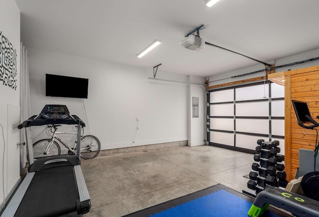 garage with baseboards and a garage door opener