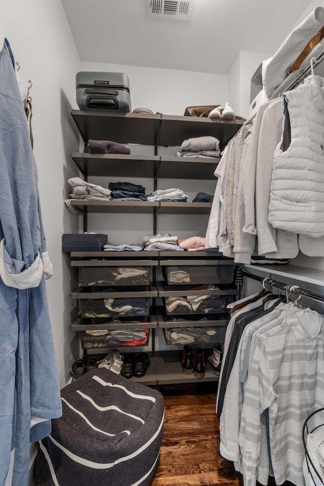 spacious closet featuring visible vents and wood finished floors