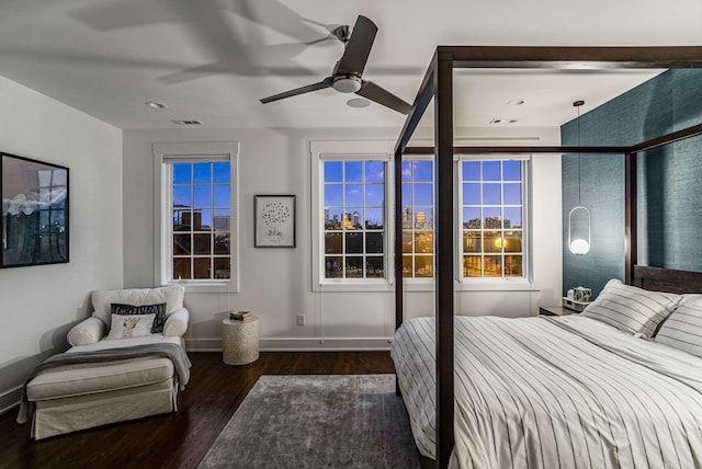 bedroom with a ceiling fan, visible vents, multiple windows, and wood finished floors