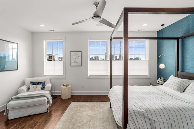 bedroom featuring dark wood-style floors, a ceiling fan, and baseboards