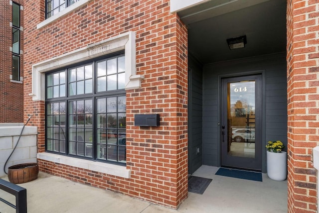 property entrance featuring brick siding