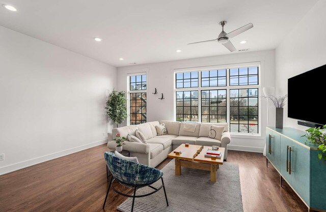 living room with recessed lighting, dark wood-style flooring, and baseboards