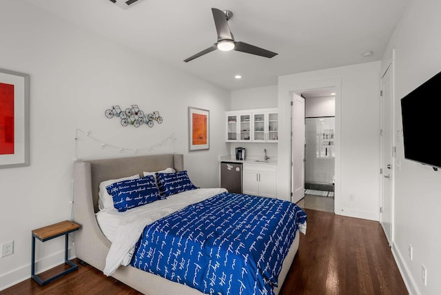 bedroom featuring stainless steel fridge, baseboards, wood finished floors, a sink, and recessed lighting