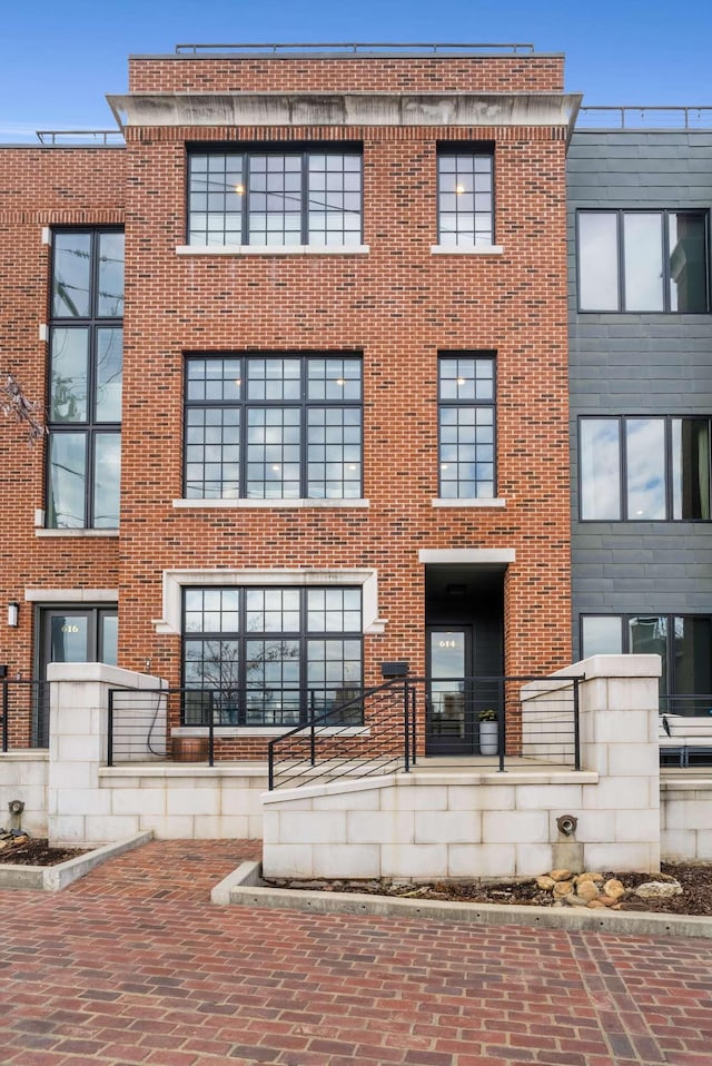 back of property featuring brick siding