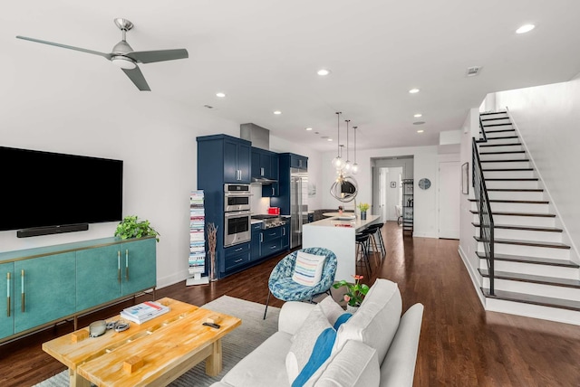 living area with dark wood-style floors, ceiling fan, stairway, and recessed lighting