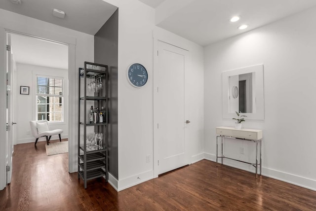 hall with recessed lighting, dark wood finished floors, and baseboards