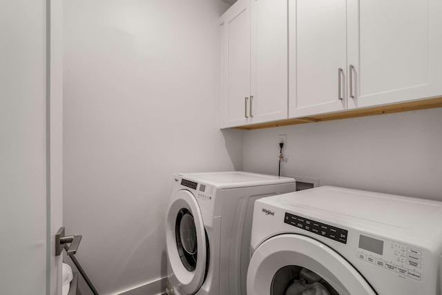 laundry area featuring washer and dryer and cabinet space