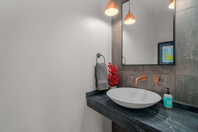 bathroom featuring tasteful backsplash and a sink