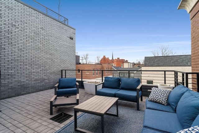 view of patio featuring a balcony, outdoor lounge area, and a city view