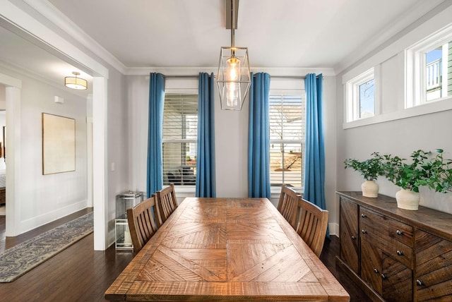 dining room with ornamental molding, dark wood-type flooring, and baseboards