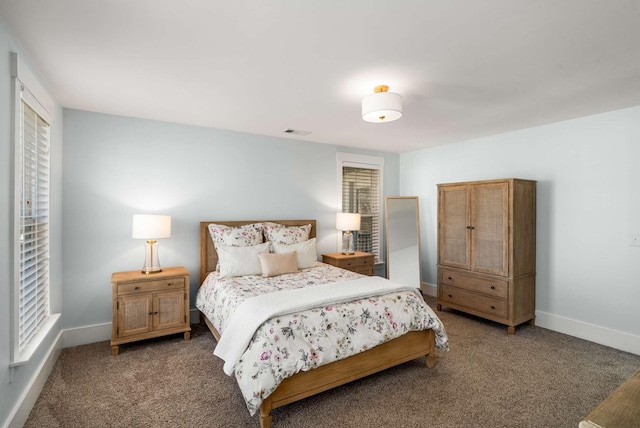 carpeted bedroom with baseboards and visible vents