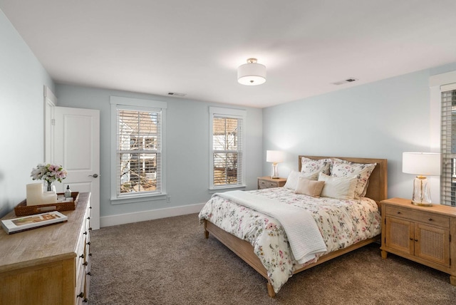 carpeted bedroom with visible vents and baseboards