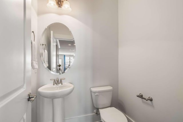 bathroom with toilet and a sink