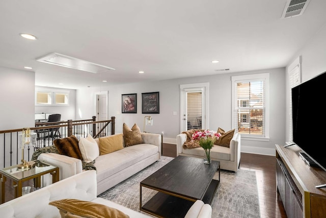 living area featuring attic access, recessed lighting, dark wood-style flooring, and visible vents