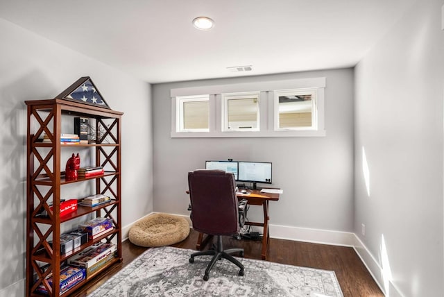 office featuring dark wood-type flooring, visible vents, and baseboards