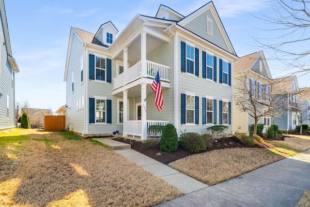 view of front facade featuring covered porch and a balcony