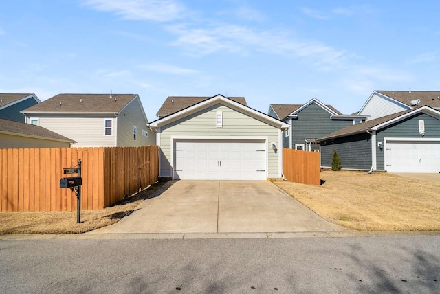 view of front facade with a garage and fence