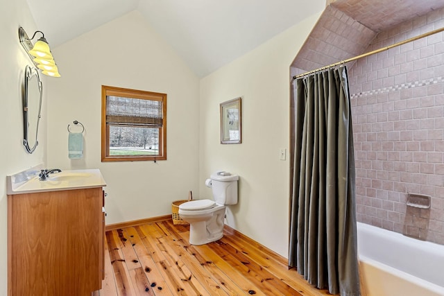 full bath featuring lofted ceiling, toilet, shower / tub combo, vanity, and hardwood / wood-style floors