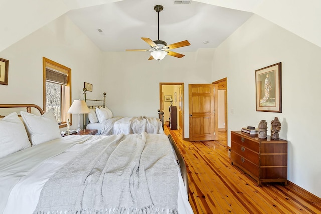 bedroom with light wood-type flooring, high vaulted ceiling, visible vents, and a ceiling fan