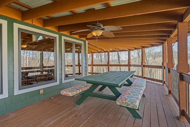 sunroom with a wealth of natural light, ceiling fan, and beamed ceiling