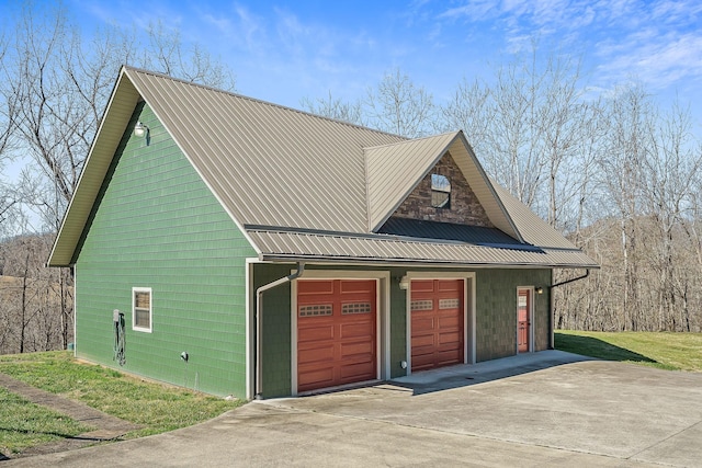 garage featuring concrete driveway