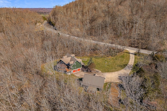 bird's eye view with a wooded view