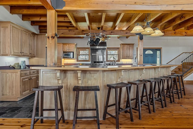 bar featuring wooden ceiling, stairs, beam ceiling, stainless steel microwave, and dark wood finished floors