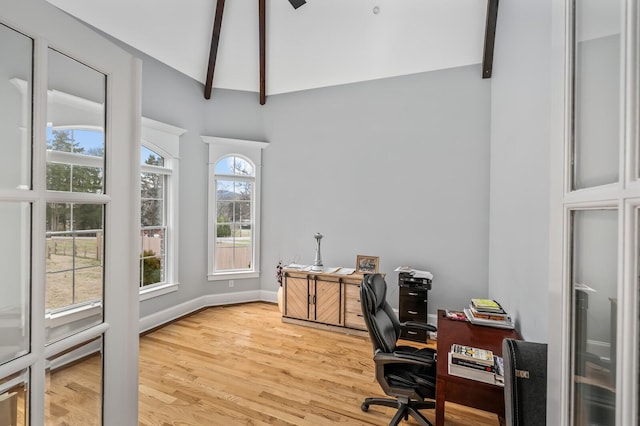 office area with light wood finished floors, beamed ceiling, and baseboards