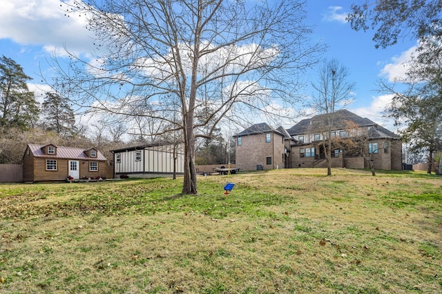 view of yard with fence and an outdoor structure