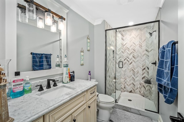 full bathroom featuring vanity, ornamental molding, a shower stall, and toilet