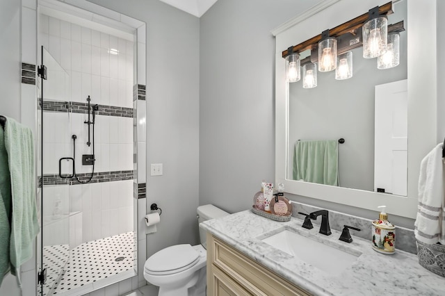 bathroom with vanity, a shower stall, and toilet