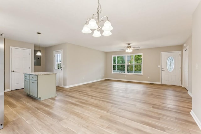 kitchen with light wood-type flooring, plenty of natural light, light countertops, and a center island