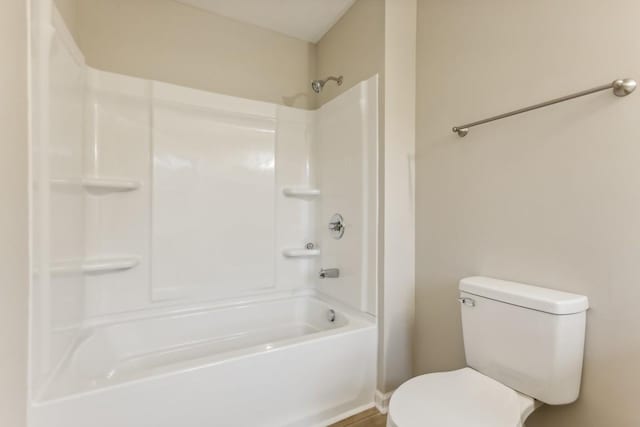 bathroom featuring walk in shower and toilet