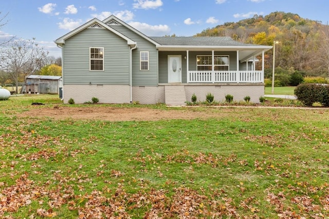 single story home with a porch and a front yard