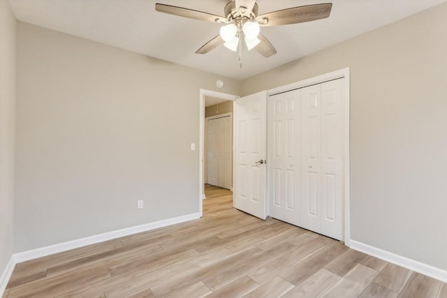 unfurnished bedroom featuring light wood finished floors, a closet, a ceiling fan, and baseboards