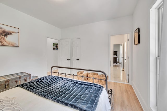 bedroom featuring baseboards and light wood-style floors