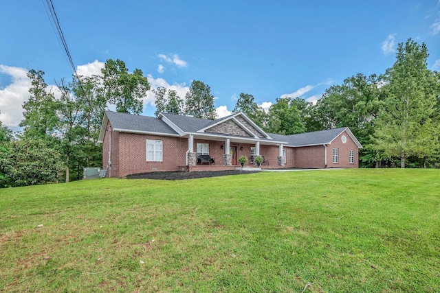 view of front of house featuring crawl space, a porch, a front lawn, and brick siding