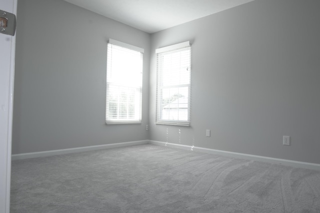 spare room with carpet flooring and baseboards