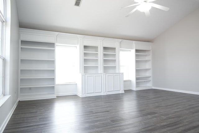 unfurnished bedroom featuring dark wood-type flooring, lofted ceiling, visible vents, and baseboards