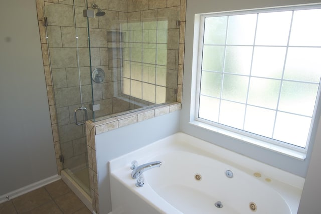 bathroom with a whirlpool tub, a shower stall, and tile patterned floors