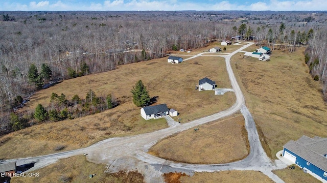 birds eye view of property featuring a wooded view